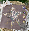 Camo Star — a camouflage-patterned star with hanging ribbon details