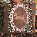 Deer - Camo Stripes — a deer silhouette in a pink decorative frame over camouflage stripes